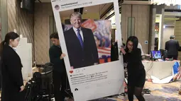 Kardus bergambar Donald Trump diangkat petugas saat menonton siaran langsung pemilihan presiden AS yang digelar di Kedutaan Besar Seoul, Korea Selatan, Rabu (9/11). (AP Photo / Lee Jin-man)