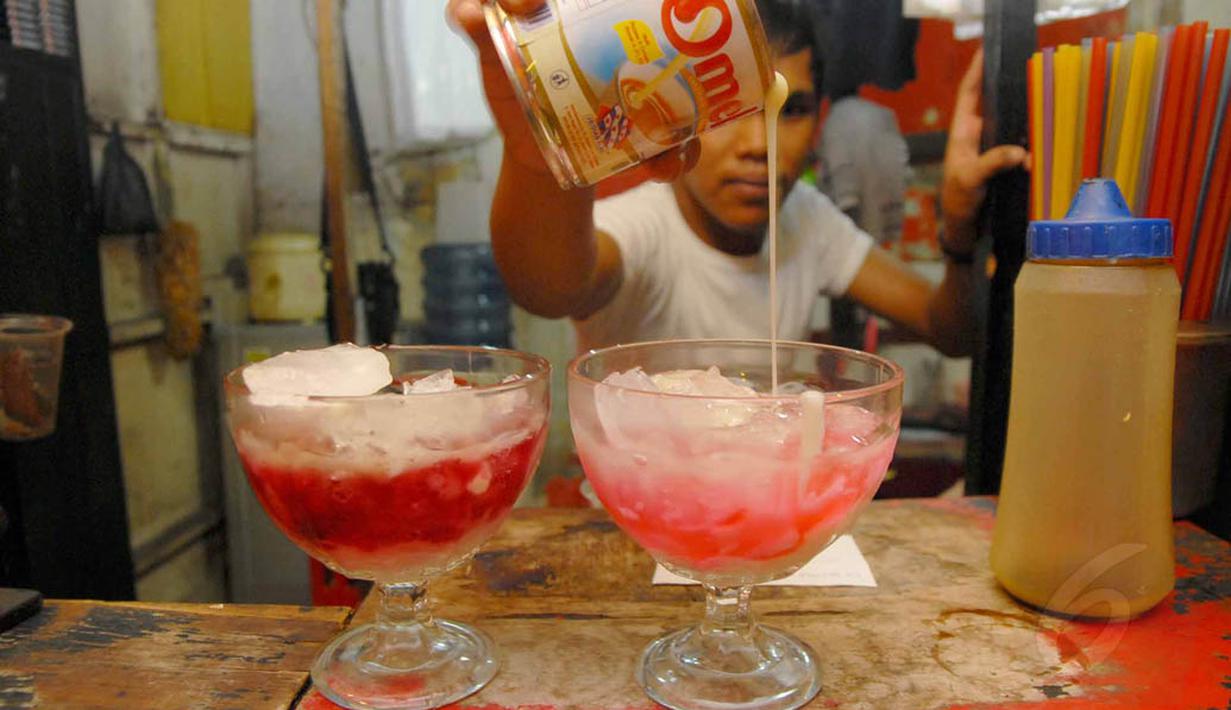 Es pocong adalah bubur sumsum yang dicampur dengan potongan pisang tanduk, diberi es batu dan di atasnya disiram sirup berwarna merah muda, Depok, Kamis (3/7/14). (Liputan6.com/Miftahul Hayat) 