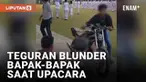Insiden warga numpang lewat terjadi saat upacara HUT ke-77 RI. Seorang pemuda menuntun motor melewati para hadirin yang tengah khusyuk. Seorang bapak menegur pemuda tersebut dan menunjuk arah bendera untuk menghormati. Namun warganet justru fokus pad...