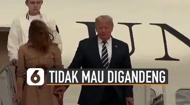 Beredar video Istri Donald Trump tidak mau digandeng oleh suaminya sendiri saat menuruni tangga pesawat Air Force One.