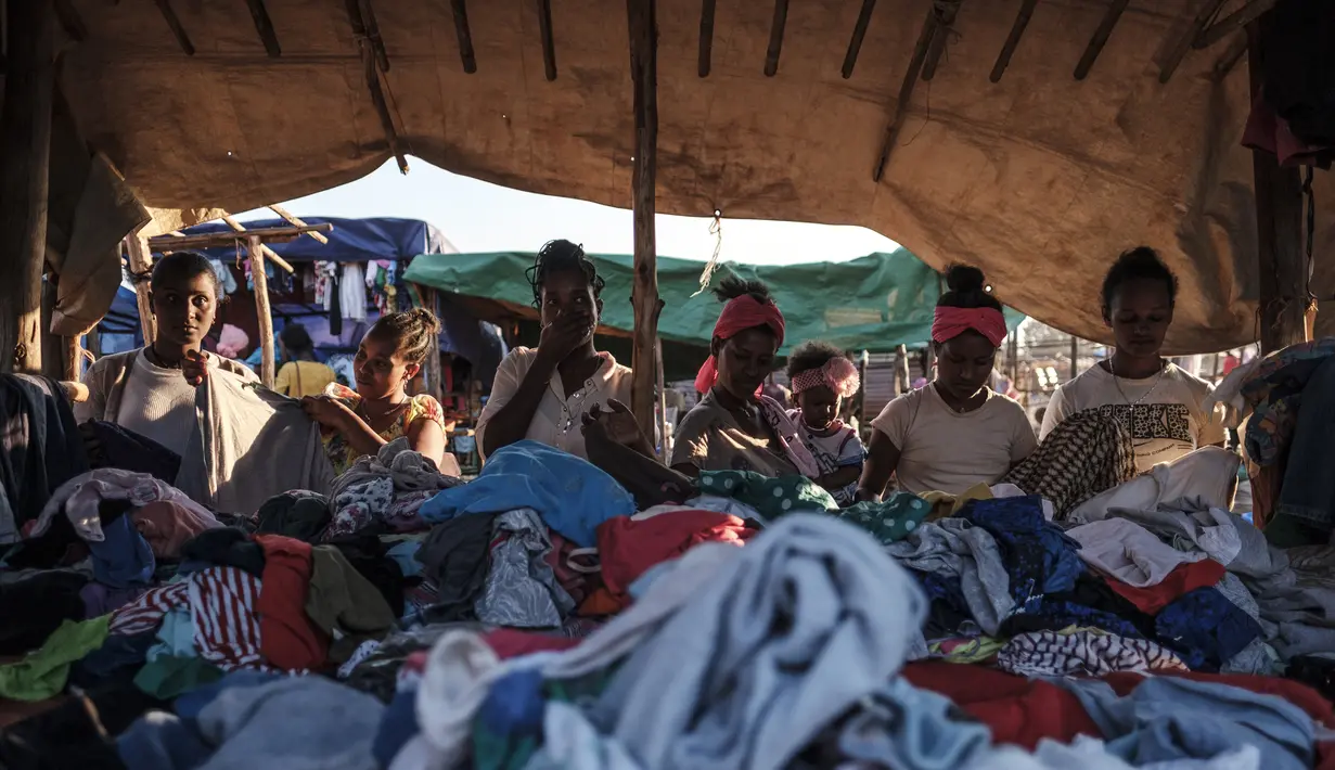 Sejumlah wanita membeli pakaian di sebuah kios pasar lokal di Kota Asosa, Ethiopia, Rabu (25/12/2019). (EDUARDO SOTERAS/AFP)