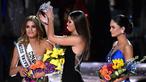 Miss Universe 2014, Paulina Vega saat mengambil kembali mahkota yang sempat disematkan ke Miss Kolombia, untuk diberikan kepada Miss Universe 2015, Pia Alonzo Wurtzbach di The AXIS Las Vegas, AS, Minggu (20/12). (Ethan Miller/Getty Images/AFP)
