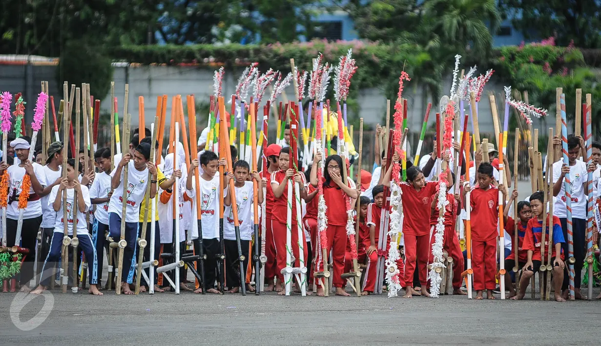 Sejumlah anak SD dan SMP bersiap memecahkan rekor dunia egrang yang termasuk dalam rangkaian penyelenggaraan TAFISA World Games 2016 di Kemayoran, Jakarta, Sabtu (8/10). Pemecahan rekor Guinness Book itu diikuti 2.016 anak. (Liputan6.com/Faizal Fanani)
