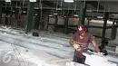 Pekerja menyelesaikan pembangunan Tempat Penampungan Sementara (TPS) Pasar Senen Blok VI sisi Jalan Bungur, Jakarta, Selasa (27/12). Revitalisasi pasca kebakaran itu ditargetkan selesai awal bulan Januari 2017 mendatang. (Liputan6.com/Immanuel Antonius)