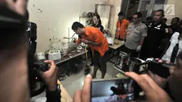 Tersangka menunjukkan proses pembuatan liquid vape narkoba di Kelapa Gading, Jakarta, Rabu (31/10). Tersangka menjual liquid vape narkoba yang dikemas dalam botol kecil dengan kisaran harga Rp 350-450 ribu per buah. (Merdeka.com/Iqbal Nugroho)