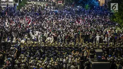 Massa aksi dari Gerakan Nasional Kedaulatan Rakyat berunjuk rasa di depan Gedung Bawaslu, Jakarta, Selasa (21/5/2019). Dalam aksinya yang dijaga aparat kepolisian, mereka meminta Bawaslu memeriksa hasil perolehan suara Pemilu 2019 yang dinilai banyak kecurangan. (Liputan6.com/Faizal Fanani)