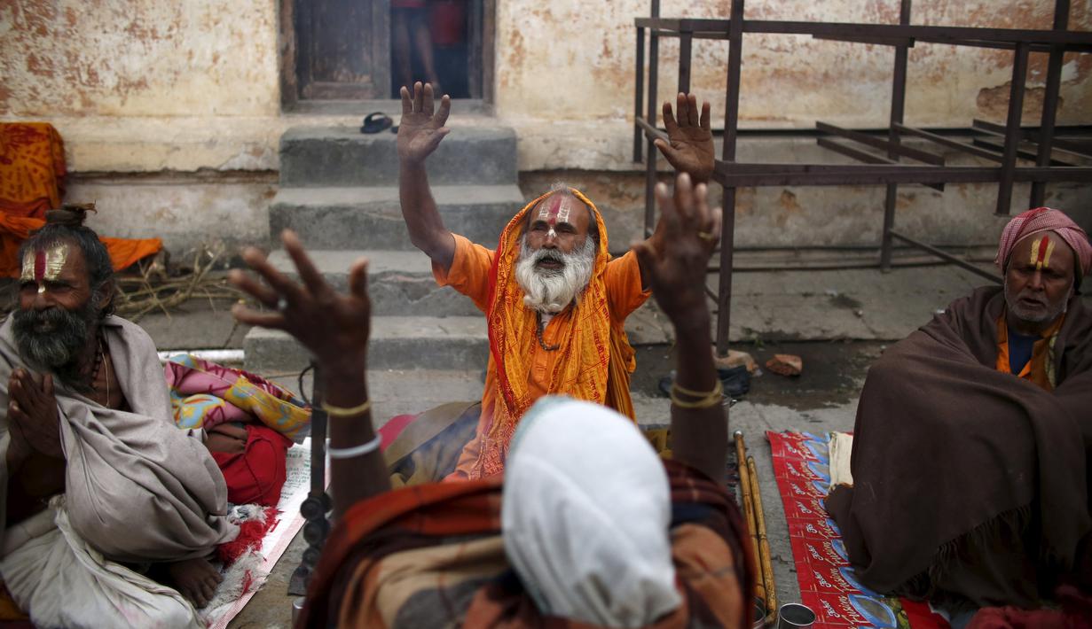 Orang suci dalam kepercayaan Hindu atau disebut sadhus berdoa di Kuil Pashupatinath,  Kathmandu , Nepal, (6/3). Para Sadhus merayakannya dengan berdoa , merokok ganja atau mengolesi tubuh mereka dengan abu . (REUTERS / Navesh Chitrakar)