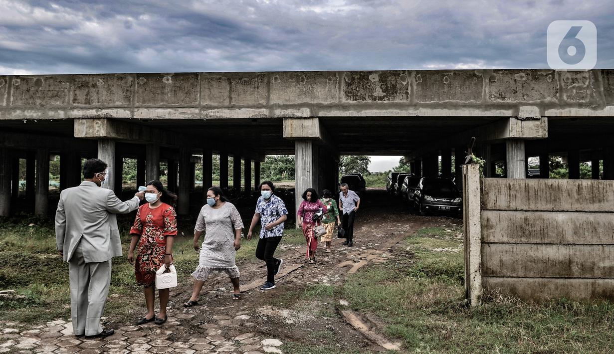 Panitia memeriksa suhu tubuh jemaat HKBP Filadelfia sebelum ibadah malam Natal di Gedung Serbaguna Mandiri Sejahtra CBL, Desa Sumber Jaya, Tambun, Bekasi, Jawa Barat, Kamis (24/12/2020). Panitia HKBP Filadelfia tetap mematuhi protokol kesehatan. (merdeka.com/Iqbal S. Nugroho)