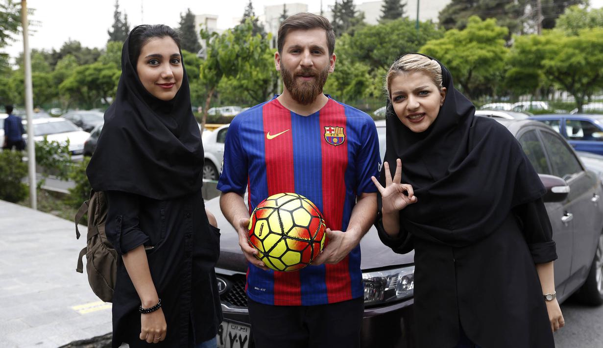 Reza Parastesh, seorang warga Iran yang memiliki wajah mirip Lionel Messi diajak foto bareng oleh warga di jalanan Tehran, Iran, Senin (8/5/2017). (AFP/Atta Kenare)