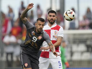 Penyerang Makedonia Utara Aleksandar Trajkovski berebut bola dengan bek Kroasia Martin Erlic pada laga uji coba internasional menjelang Piala Eropa 2024 di stadion Rujevica Selasa (4/6/2024) dini hari. (AP Photo/Darko Bandic)