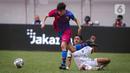 Pemain Barcelona U-18 Joan Anaya Balaña (kiri) menggiring bola meninggalkan pemain Bali United U-18 Anak Agung Dwi Trisna Putra pada pertandingan International Youth Championship (IYC) 2021 di Jakarta International Stadium (JIS), Jakarta, Minggu (17/4/2022). (Liputan6.com/Faizal Fanani)