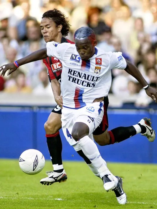 Gelandang Lyon, Michael Essie membawa bola dari kawalan penyerang Nice, Marama Vahirua di Liga Prancis di Stadion Gerland pada 28 Mei 2005. Kedatangan Essien membuat manajemen Persib mentargetkan juara Liga 1 Indonesia tahun ini. (AFP Photo/ Fred Dufour)