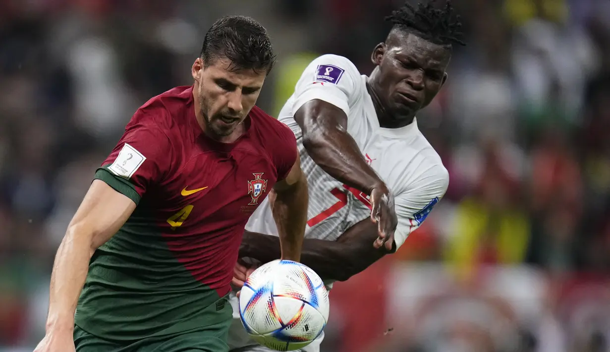 Bek Portugal Ruben Dias ditantang oleh penyerang Swiss Breel Embolo dalam laga 16 besar Piala Dunia 2022 di Stadion Lusail Iconic, Rabu (7/12/2022) dini hari WIB. Timnas Portugal sukses membungkam Timnas Swiss dengan skor 6-1. (AP Photo/Manu Fernandez)