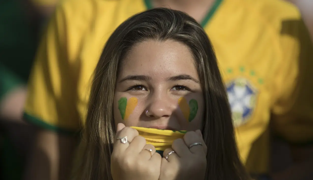 Ekspresi tegang suporter cantik asal Brasil saat menonton laga timnya melawan Swis di Rio de Janeiro, Brasil, (17/6/2018). Brasil dan Swis bermain imbang 1-1. (AP/Leo Correa)
