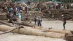 Warga yang menjadi korban banjir bandang di Batang Toru, Tapanuli Selatan, Sumatra Utara menggunakan kayu gelondongan untuk menyeberangi sungai, Selasa 2 Desember 2025. Warga Batang Toru, Tapanuli Selatan, terpaksa menggunakan jembatan darurat yang terbuat dari gelondongan kayu untuk menyeberangi sungai setelah jembatan utama rusak akibat terjangan banjir bandang baru-baru ini. (AP Photo/Binsar Bakkara)