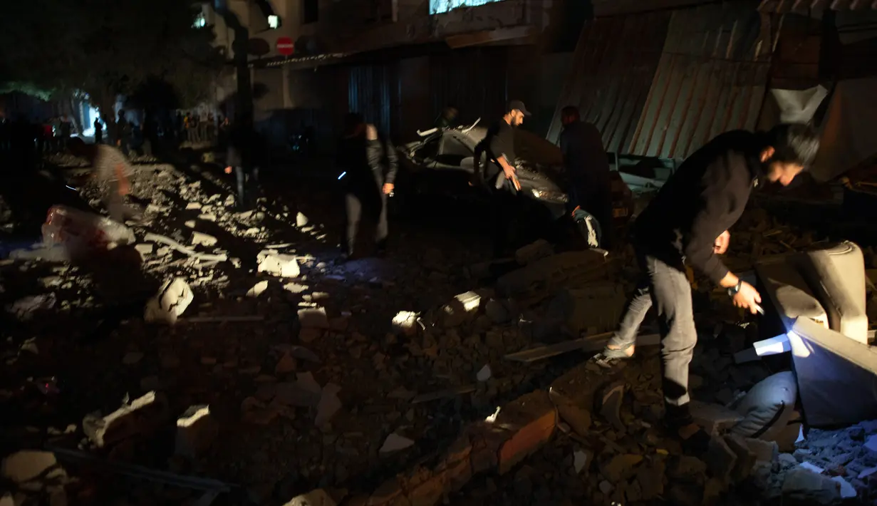 Warga memeriksa rumah komandan Jihad Islam Baha Abu Al-Ata setelah serangan rudal Israel di Kota Gaza, Palestina, Selasa (12/11/2019). Sejumlah warga di lokasi kejadian menuturkan sebuah ledakan menerjang rumah Ata yang terletak di Distrik Shejayia, timur Kota Gaza. (AP Photo/Khalil Hamra)