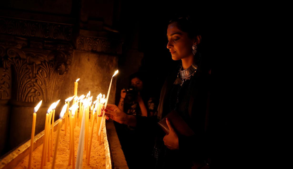 Sonam Kapoor membawa lilin saat mengunjungi Gereja Makam Suci di Kota Tua Yerusalem 30 Mei 2016. Dia adalah salah satu aktris dengan bayaran tertinggi dan selebriti paling modis di India. (REUTERS / Ammar Awad)