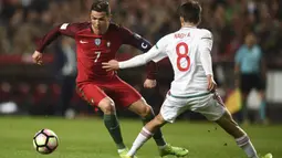 Striker Portugal, Cristiano Ronaldo, berusaha melewati gelandang Hongaria, Adam Nagy, pada laga kualifikasi Piala Dunia di Stadion Luz, Sabtu (25/3/2017). Cristiano Ronaldo meraih gelar pemain terbaik FIFA 2017. (AFP/Patricia De Melo Moreira)