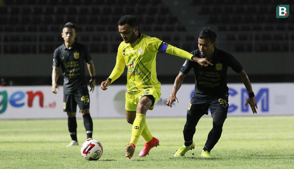 Penyerang Barito Putra, Rizky Pora (tengah), berebut bola dengan pemain PSIS Semarang, Komarudin, pada laga Piala Menpora di Stadion Manahan, Solo, Minggu (21/3/2021). Kedua tim bermain imbang 3-3. (Bola.com/M Iqbal Ichsan)