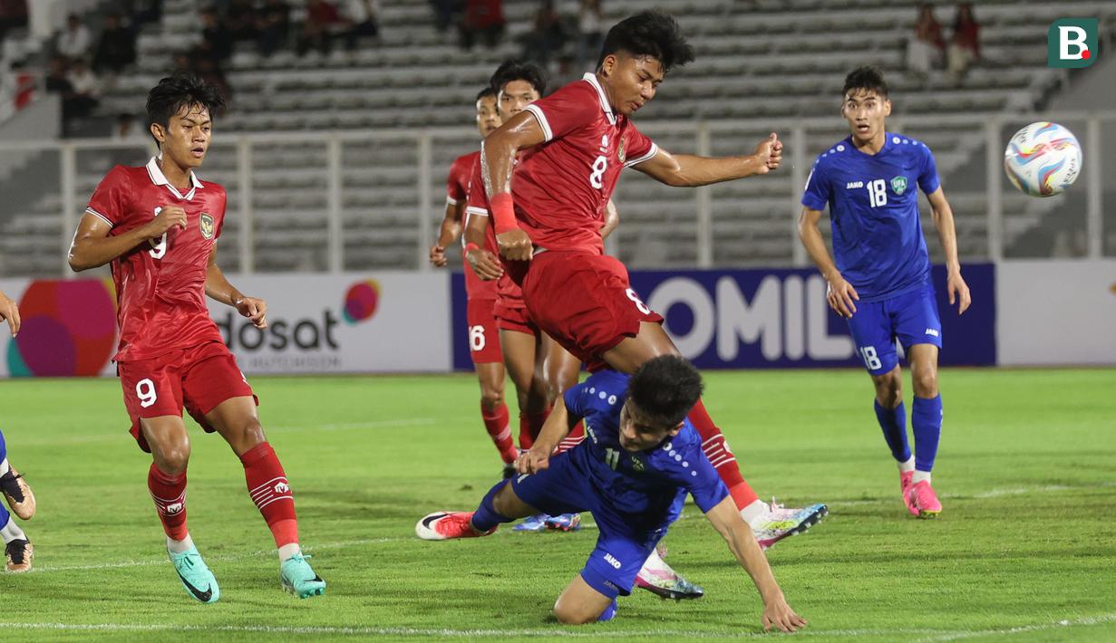 <p>Striker Timnas Indonesia U-20, Arkhan Kaka (atas) melepaskan tendangan yang berusaha diblok gelandang Uzbekistan U-20, Murodjon Komilov pada laga uji coba internasional di Stadion Madya, Senayan, Jakarta, Selasa (30/1/2024). (Bola.com/M Iqbal Ichsan)</p>