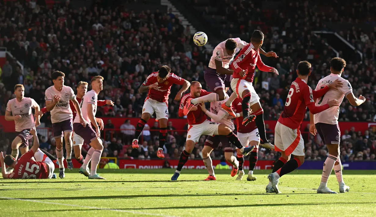 Pemain Brentford, Ethan Pinnock mencetak gol pembuka ke gawang Manchester United pada laga lanjutan Liga Inggris di Old Trafford, Manchester, Inggris, Sabtu (19/10/2024). (AFP/Oli Scarff)