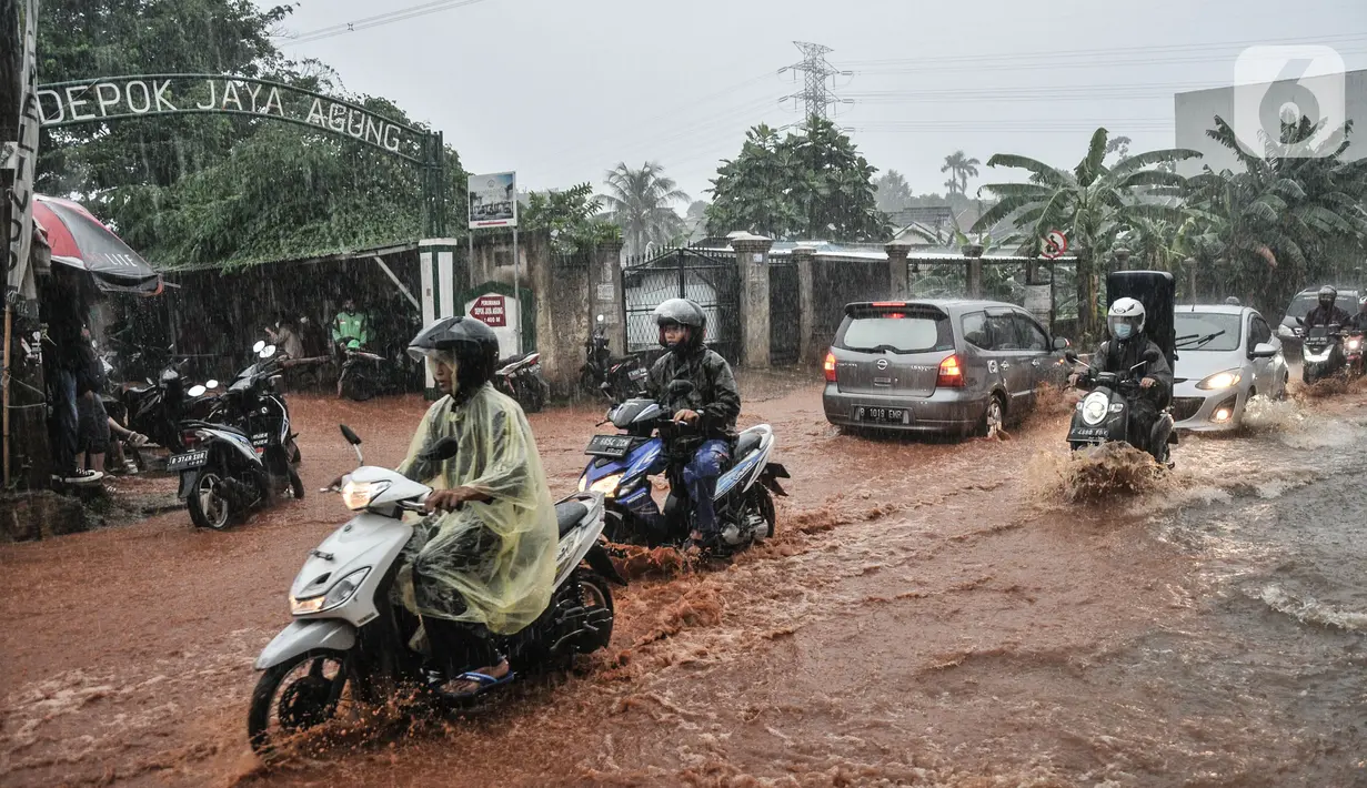 Kendaraan bergerak perlahan melintasi genangan lumpur di Jalan Raya Sawangan, Depok, Minggu (7/11/2021). Hujan deras yang mengguyur Depok dan sekitarnya menyebabkan Jalan Raya Sawangan yang berada tepat di depan Perumahan Depok Jaya Agung itu digenangi banjir lumpur. (merdeka.com/Iqbal S Nugroho)
