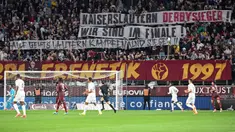 Suporter FC Metz membentangkan spanduk bertulisakan "Pemenang derby Kaiserlautern, kami berada di final" untuk mendukung FC Kaiserlautern yang mencapai final Piala DFB Pokal pada laga lanjutan Liga Prancis 2023/2024 melawan RC Lens di Saint-Symphorien Stadium, Longeville-les-Metz, Prancis, Sabtu (13/04/2024) dini hari WIB. (AFP/Jean-Christophe Verhaegen)