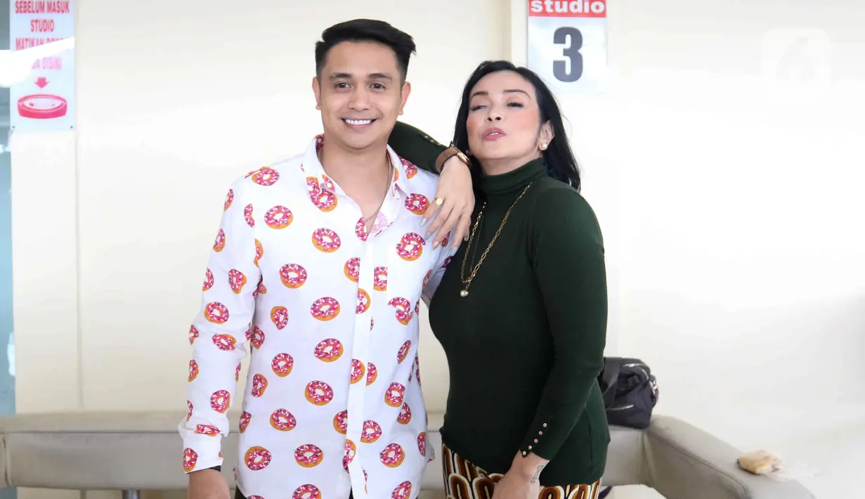 Pasangan selebritis Ajun Perwira dan Jennifer Jill berpose di kawasan Cipinang Cempedak, Jakarta, Selasa (9/8/2022). Istri dari artis Ajun Perwira, Jennifer Jill belum lama ini membagikan potret bahagia karena berhasil menurunkan berat badan hingga 24 kilo selama satu tahun. (Liputan6.com/Herman Zakharia)