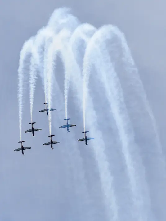Jupiter Aerobatic Team (JAT) TNI AU menerbangkan pesawat KT-1 saat tampil pada pratinjau Singapore Airshow 2022 di Singapura, Minggu (13/2/2022). Singapore Airshow 2022 akan berlangsung pada 15-18 Februari 2022. (Roslan RAHMAN/AFP)