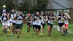 Para peserta bersaing dalam Lomba Lari Gendong Istri di The Nower, Dorking, Inggris, Minggu (3/3). Para suami harus menggendong istri mereka dari garis start hingga finish. (Gareth Fuller/PA via AP)