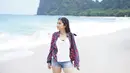 Penampilan Tissa saat tengah berlibur di pantai ini juga bisa ditiru. Ia memilih menggunakan kaus berwarna putih dengan kemeja kotak sebagai outer serta menambahkan kacamata untuk pelengkap. (Liputan6.com/IG/tissabiani)