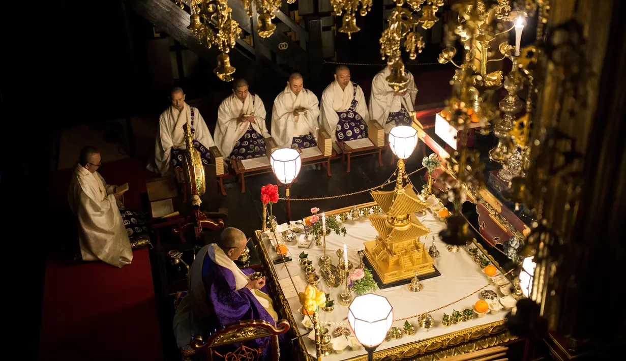 Sejumlah biksu memanjatkan doa sebelum melemparkan tongkat suci kepada ribuan peserta Hadaka Matsuri atau Festival Pria Telanjang, Jepang, Sabtu (18/2). Peserta percaya jika mendapat tongkat akan memperoleh keberuntungan. (AFP PHOTO / Behrouz MEHRI)
