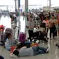 Calon penumpang menunggu jadwal keberangkatan pesawat di bandara Hong Kong, Rabu (14/8/2019). Bandara Hong Kong kembali membuka penerbangan keberangkatan pada Rabu pagi setelah sempat lumpuh selama dua hari akibat demonstran menduduki salah satu bandara tersibuk di dunia tersebut. (AP/Vincent Thian)