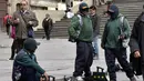 Para tukang semir sepatu bertopeng menunggu pelanggan di kawasan La Paz, Bolivia (29/11). Karena diantara mereka masih ada yang menjalani pendidikan di sekolah dan universitas para tukang semir ini menutup wajahnya. (AFP PHOTO/Aizar Raldes)