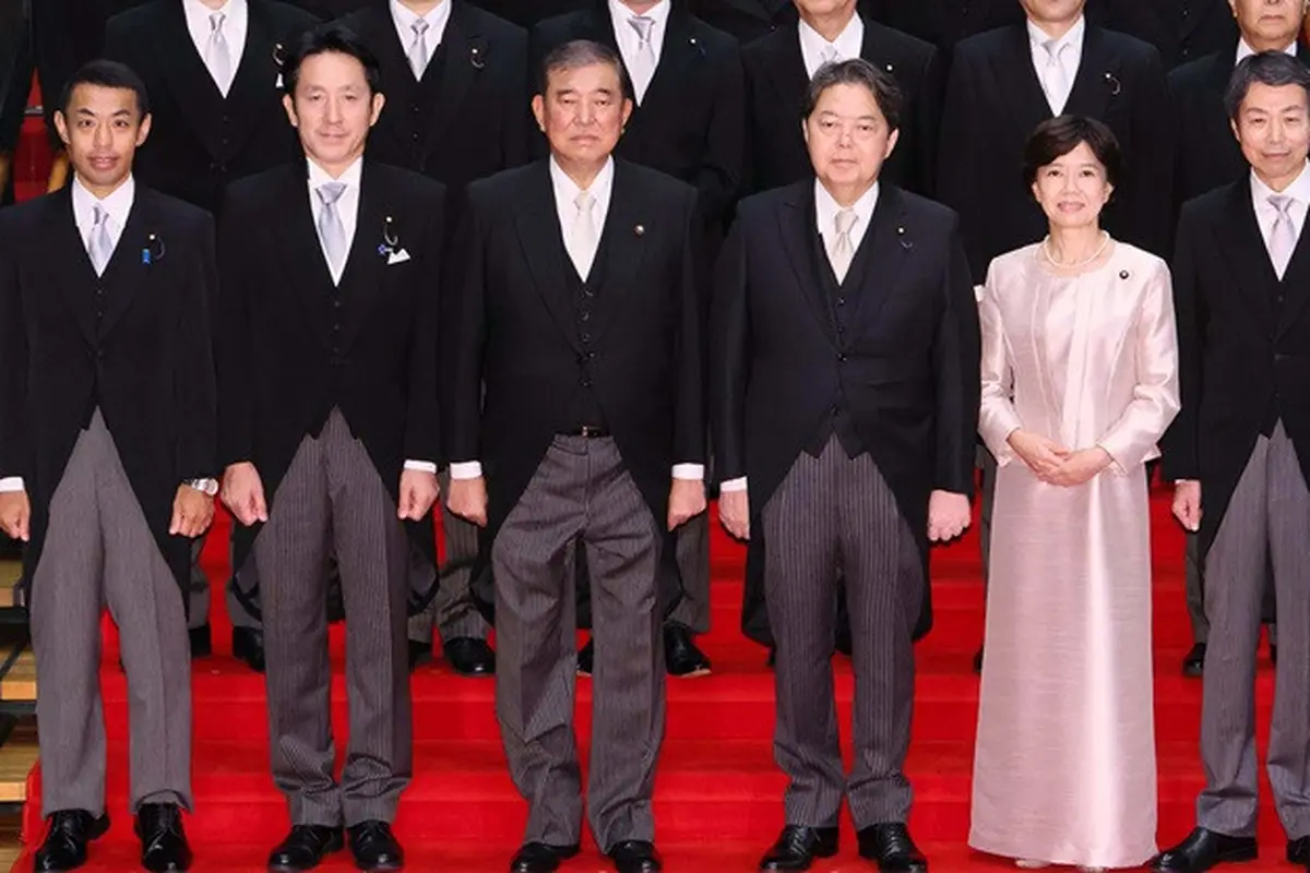 Perdana Menteri Shigeru Ishiba (ketiga dari kiri) dan menteri pertahanannya (keempat dari kiri) berpose dalam foto resmi kabinet. Foto ini yang kemudian diakui telah mengalami penyuntingan kecil agar terlihat lebih rapi.