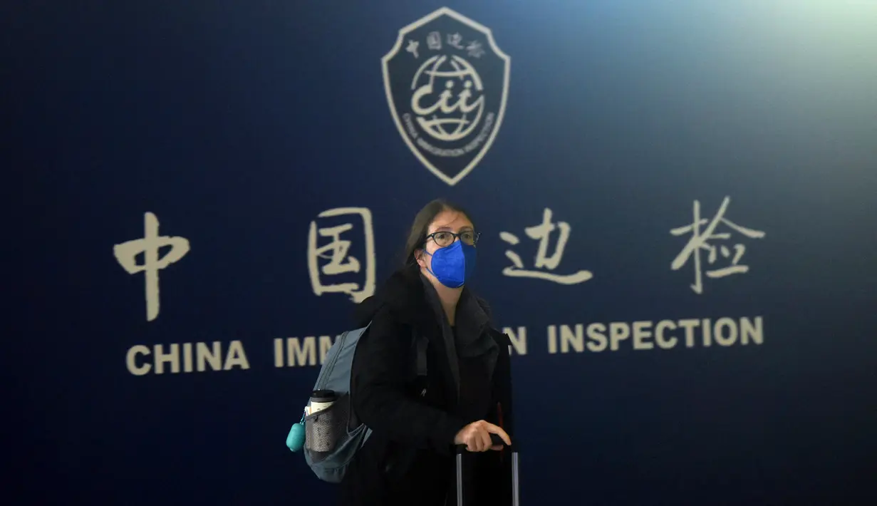Seorang penumpang berjalan keluar saat melewati bea cukai setelah tiba di Bandara Internasional Xiaoshan Hangzhou di provinsi Zhejiang timur China (8/1/2023).  China mencabut persyaratan karantina untuk pelancong yang datang pada (8/1), mengakhiri isolasi yang diberlakukan sendiri selama hampir tiga tahun bahkan saat negara tersebut berjuang melawan wabah lonjakan kasus Covid. (AFP/STR)