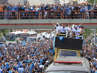 Pemain dan suporter Gremio merayakan keberhasilan meraih juara Copa Libertadores dengan pawai di Porto Alegre, Brasil, Kamis (30/11/2017). Gremio menjadi juara Copa Libertadores setelah mengalahkan Lanus dengan skor agregat 3-1. (AFP/Itamar Aguiar)