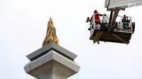 Pengunjung menaiki Bronto Skylift yang disediakan petugas pemadam kebakaran di Monas, Jakarta, Minggu (23/11). Bronto Skylift merupakan fasilitas yang disediakan Pemprov DKI Jakarta untuk melihat Monas dari dekat. (Liputan6.com/JohanTallo)