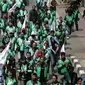 Massa dari pengemudi ojek online membentangkan spanduk sambil bergerak menuju Istana Negara, Jakarta, Senin (15/5). Mereka menuntut agar pemerintah segera merevisi UU No 22 Tahun 2009 tentang Lalu Lintas dan Angkutan Jalan. (Liputan6.com/Faizal Fanani)