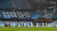 Para pemain mengheningkan cipta satu menit jelang laga Premier League antara Manchester City dan Arsenal di Etihad Stadium, Manchester, Inggris, Rabu (17/6/2020). Manchester City menang dengan skor 3-0. (PETER POWELL/POOL/AFP)