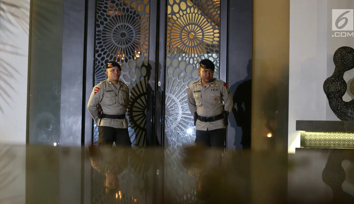 Dua aparat kepolisian Brimob berjaga di depan pintu rumah tersangka Ketua DPR RI Setya Novanto di Jalan Wijaya 13 No 19, Jakarta Selatan, Rabu (15/11). (Liputan6.com/Johan Tallo)