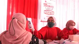Tenaga kesehatan mengukur suhu tubuh peserta vaksinasi booster di Kantor Bank DKI Kantor Layanan Juanda, Jakarta (5/3/2022). Untuk mendukung pencegahan dan penanganan Covid-19 di Jakarta, Bank DKI bersama Dinas Kesehatan DKI Jakarta menggelar Sentra Vaksinasi Booster. (Liputan6.com/HO/BDKI)