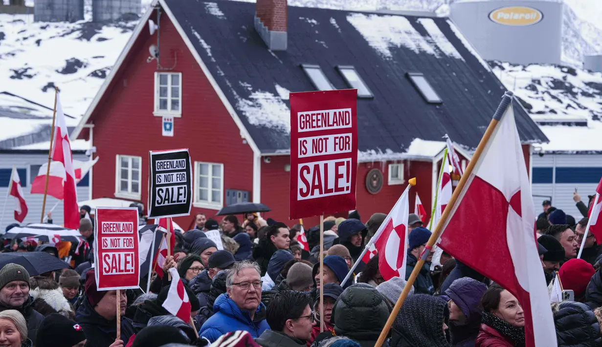 Sikap Trump memicu reaksi keras dari Eropa, termasuk langkah Denmark yang meminta dukungan militer sekutu NATO untuk memperkuat Greenland. Tampak dalam foto, warga berdemonstrasi menentang kebijakan Presiden Amerika Serikat (AS), Donald Trump, terhadap Greenland di depan konsulat AS di Nuuk, Sabtu 17 Januari 2026. (AP Photo/Evgeniy Maloletka)