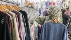 Warga memilih pakaian yang dijual di Pasar Tanah Abang, Jakarta, Minggu (1/12/2024). (Liputan6.com/Herman Zakharia)