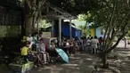 Para siswa mengikuti pelajaran di bawah pohon saat sekolah diubah menjadi pusat evakuasi sementara di kota Malilipot, provinsi Albay, Filipina timur laut, Kamis, 15 Juni 2023. Ribuan warga telah meninggalkan komunitas petani yang sebagian besar miskin dalam radius 6 kilometer (3,7 mil) dari kawah Mayon untuk mengungsi secara paksa sejak aktivitas gunung berapi meningkat pekan lalu. (AP Photo/Aaron Favila)