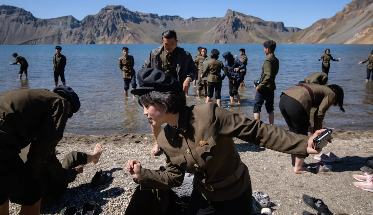 Gambar pada 11 September 2019 memperlihatkan siswa Korea Utara bermain di danau Chonji atau 'Heaven lake' saat mengunjungi kawasan Gunung Paektu di Samjiyon. 'Heaven lake' atau Danau surga ini ada di ketinggian 2.190 mdpl dan punya kedalaman 384 meter. (Photo by Ed JONES / AFP)