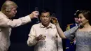 Presiden AS, Donald Trump bersulang dengan Ibu Negara Filipina, Cielito "Honeylet" Avancena disaksikan Presiden Filipina, Rodrigo Duterte dalam acara makan malam bersama konferensi ASEAN ke-31 di Manila, Minggu (12/11). (Athit Perawongmetha/Pool via AP)