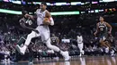 Pebasket Boston Celtics, Jayson Tatum, berusaha melewati hadangan pebasket Milwaukee Bucks, Tony Snell, pada laga NBA di TD Garden, Boston, Rabu (18/10/2017). Celtics kalah 100-108 dari Bucks. (AP/Charles Krupa)