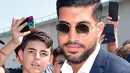 Pemain timnas Jerman, Emre Can tiba untuk menjalani tes medis di J Medical di Turin, Italia, (21/6). Can menjalani tes medis untuk masuk ke klub Juventus. (Alessandro Di Marco/ANSA via AP)