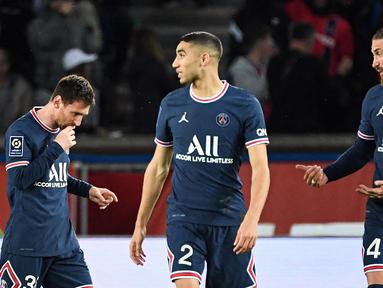 Tiga pemain baru PSG musim ini yakni Lionel Messi, Achraf Hakimi, dan Sergio Ramos&nbsp;langsung merasakan gelar juara Liga Prancis di musim pertama mereka bergabung. (AFP/Bertrand Guay)